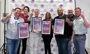 Metro Inclusive Health accepts WAVE Awards for Best Health Center, Most Effective Local Non-Profit, Trans Affirming Space and Trans Affirming Organization.