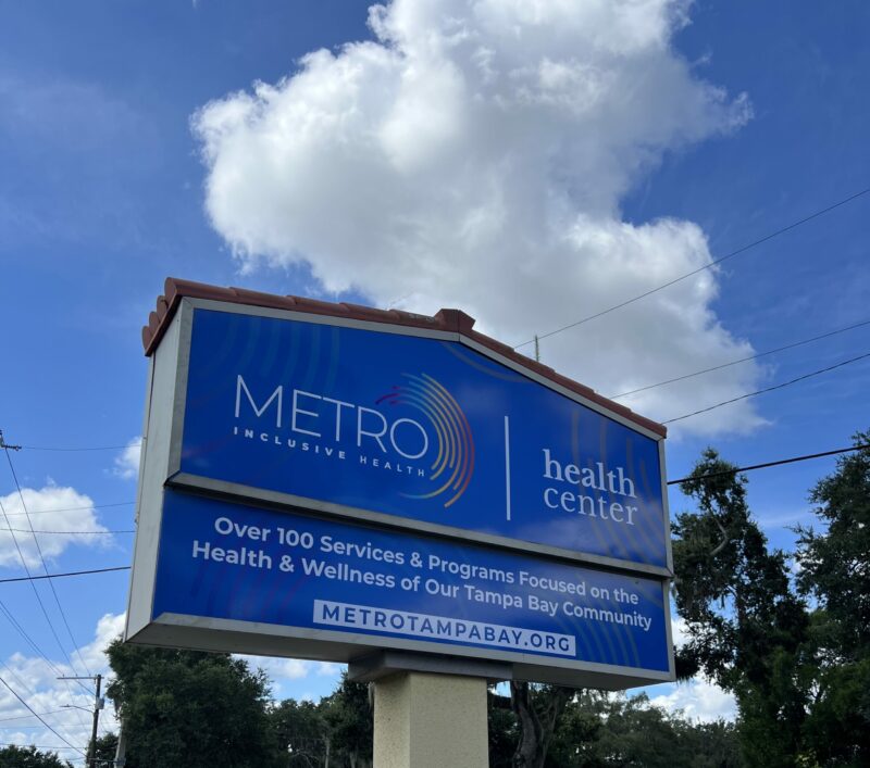 Metro Inclusive Health Brandon sign and two interior photos with blue couch and abstract art.