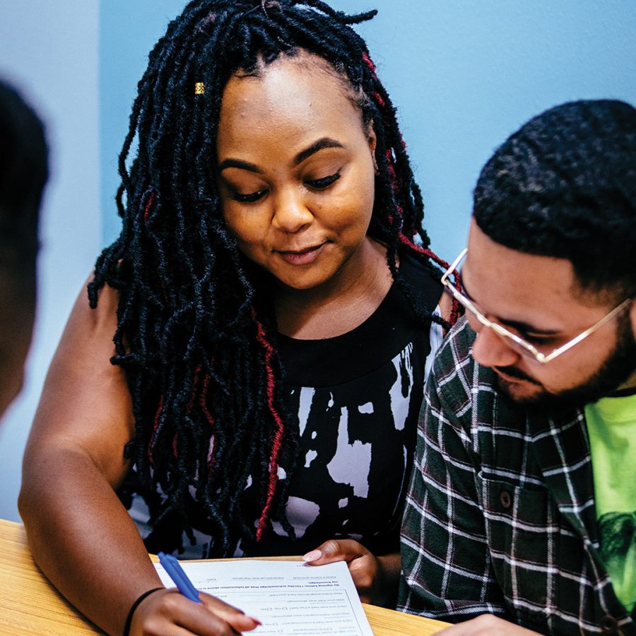 Two partners fill out medical forms